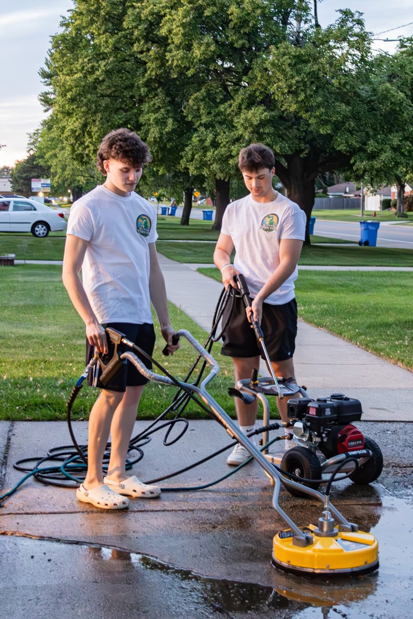 The Mitten Exterior Wash crew pressure washing a driveway in Macomb County, Michigan
